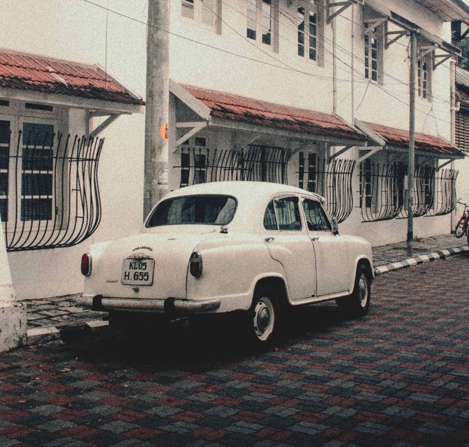 A car parked on a narrow Indian street