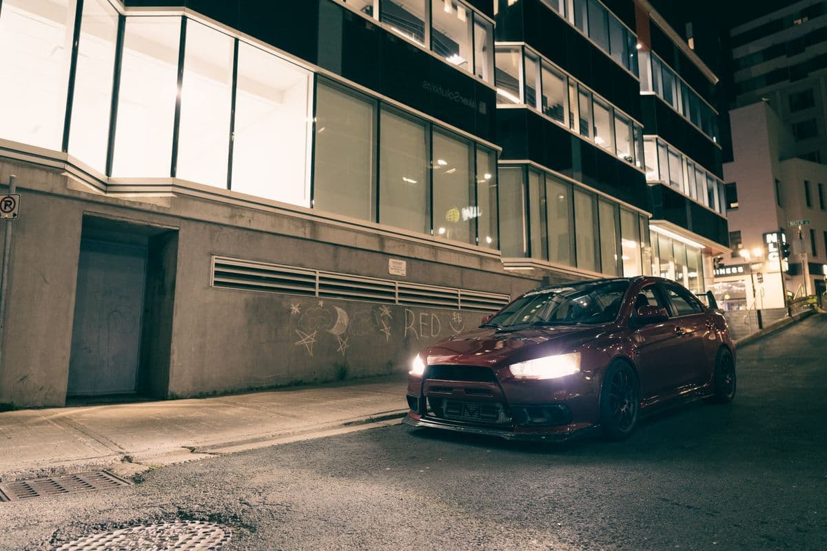 A car in a narrow lane at night